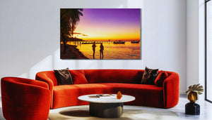 Modern living room with orange sofa, round table, and vibrant sunset beach wall art