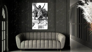 Modern dark living room with gray velvet sofa and black-and-white statue art print on wall
