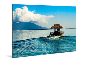 Glossy acrylic photo print featuring a tropical boat on calm blue ocean with mountain view