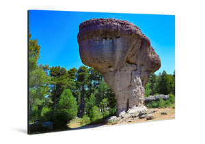 Acrylic photo print of a mushroom-shaped rock formation with trees under a blue sky.