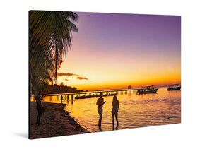 Acrylic photo print of people on a tropical beach at sunset with palm trees and boats