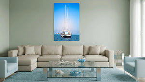 Modern living room with beige sofa, blue armchair, and sailboat wall art on light green wall