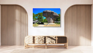 Decorative wall art of a unique rock formation and trees in a modern living room setting
