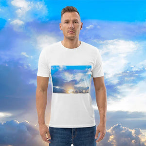 Man wearing white t-shirt with a scenic sky and sunrise art print, blue sky background