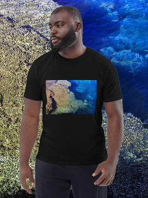 Man wearing black t-shirt with vibrant underwater coral reef photo print, ocean background