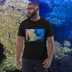 Man wearing black t-shirt with vibrant underwater coral reef photo print, ocean background