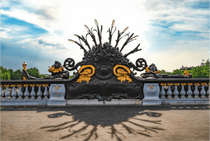 Détail noir et doré du pont Alexandre III à Paris éclairé sous un ciel bleu
