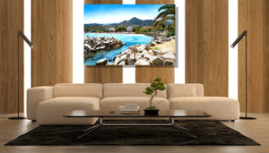 Modern living room with beige sofa, bonsai on coffee table, and coastal landscape wall art