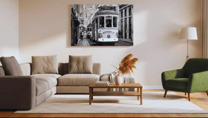 Modern living room with neutral sofa, green armchair, and tram street art wall decor