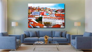 Modern living room with blue sofas, cityscape wall art, and soft lighting