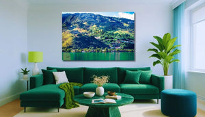 Modern living room with green sofa set, large wall art of mountain landscape above, plants and soft lighting