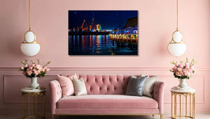 Modern living room with pink sofa, floral decor, and framed night cityscape wall art