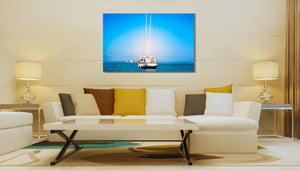 Modern living room with beige furniture, decorative pillows, and a sailboat photo wall art above the sofa.
