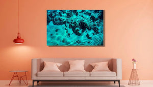 Modern living room with coral wall, beige sofa, and large underwater ocean photo art